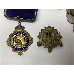 Great British and World coins including commemorative crowns, pre-decimal coinage, South Africa 1896 one shilling, King George VI Southern Rhodesia 1940 threepence etc, Bedfordshire cap badge, 'Grand Lodge of England' jewel and two hallmarked silver fobs both with enamelled decoration