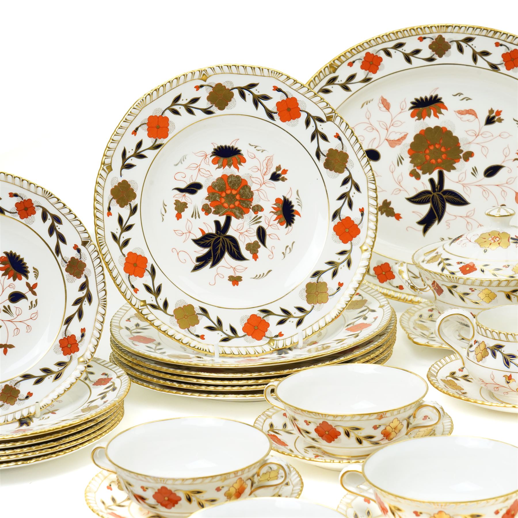 Royal Crown Derby Asian Rose pattern dinner service for twelve covers comprising  twelve dinner plates, twelve dessert plates, twelve two handled soup bowls and stands, pair of sauce boats and stands, pair of sauce tureens with covers and stands, pair of vegetable dishes and covers and two graduated meat plates, date code 1974