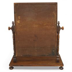 Two early 20th century mahogany swing dressing mirrors, comprising one with arched rectangular plate in a moulded frame on shaped supports, flanked by two inlaid trinket drawers (H 69cm, W 88cm, D 20cm), together with another rectangular plate mirror on turned supports upon bun feet (H 58cm, W 48cm, D 23cm)