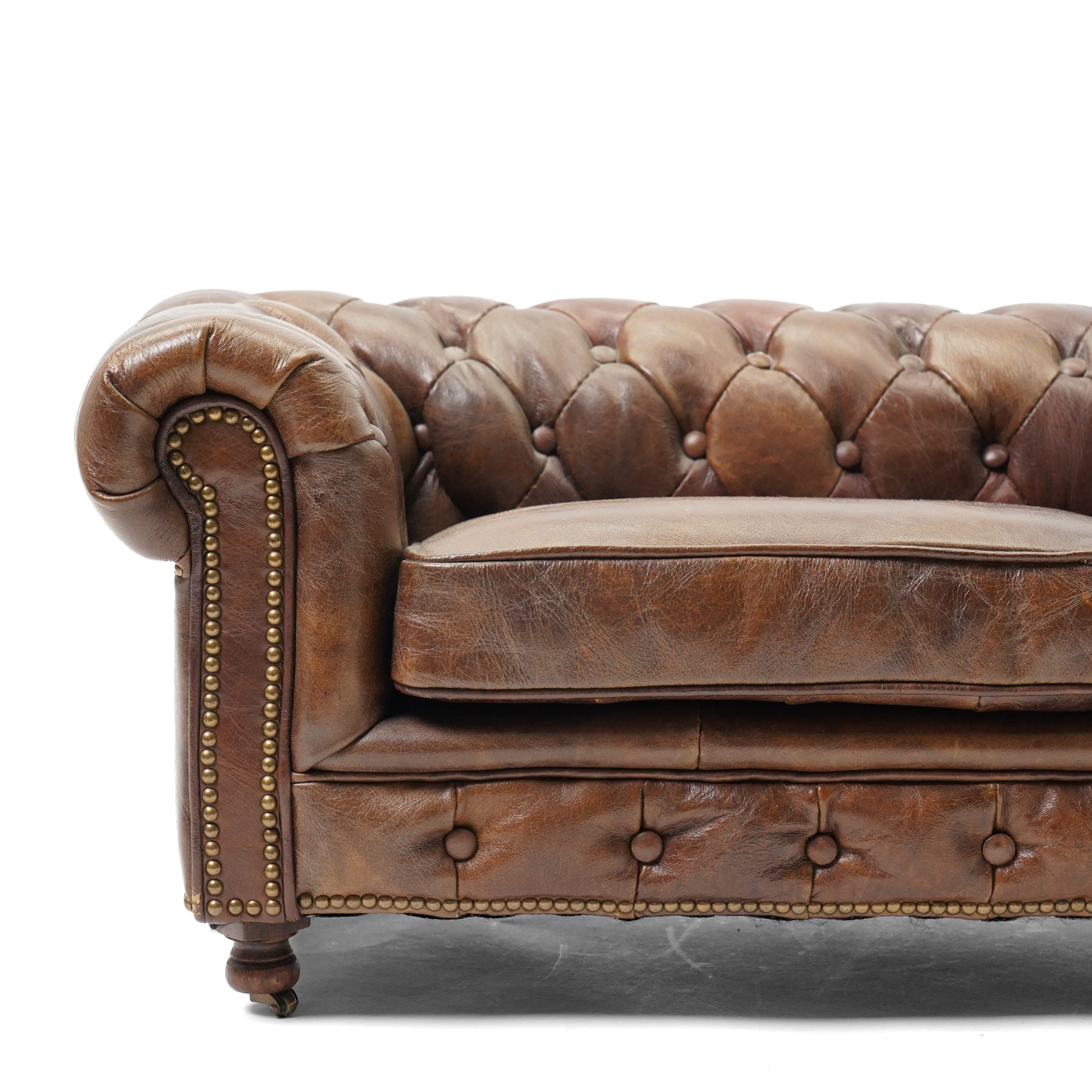 Miniature brown leather button back Chesterfield sofa, with castors 