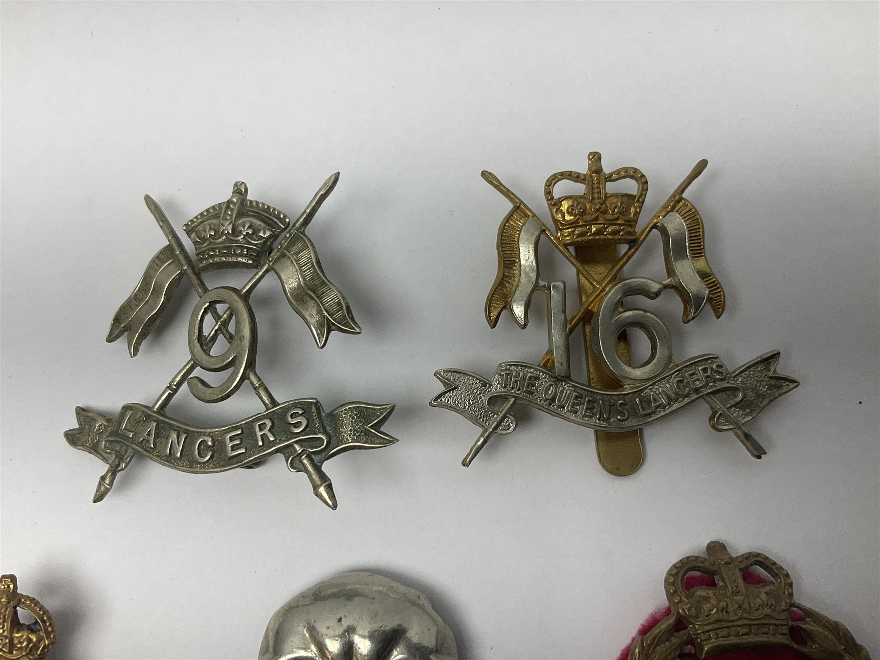 Nine Lancers metal cap badges including 9th, 12th Royals, 24th, 16th Queens and 17th; together with eight various Guards/Dragoons badges (17)