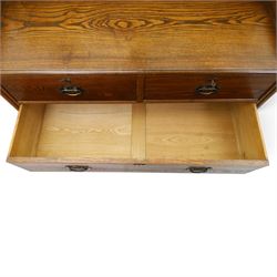 Shapland & Petter - oak mirrored dressing chest, tilted mirror flanked by tulip carved supports, shaped shelves with heart cut outs, above two short over one long drawers, with brass handles and stamped S & P on the locks, raised on shaped supports