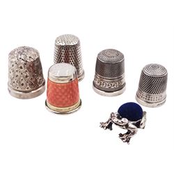 Silver orange guilloche enamel thimble, stamped 935 Sterling Silver, together with four other silver thimbles, all hallmarked and a modern silver frog pin cushion, L2cm hallmarked 