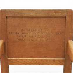 Mouseman - oak panel back carver armchair, with commemorative back panel engraved 'In memory of Fiona Mary Fotheringham Born 5th June 1958 Died 14th July 1965', above tan seat with brass studded trim, with carved Mouse signature, by Robert Thompson's of Kilburn