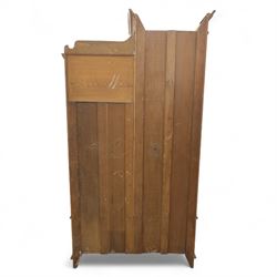 Edwardian ash combination wardrobe, moulded cornice over an open compartment and single cupboard door with carved scroll decoration, above two short and one long drawer fitted with brass handles, on shaped bracket supports