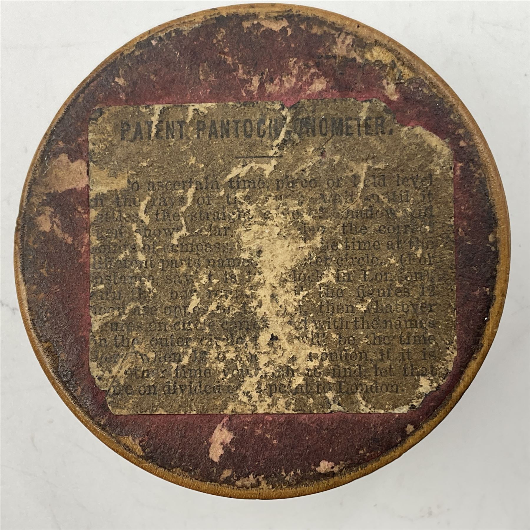 19th century pocket sundial compass pantochronometer, central sun dial pivoting with angled gnomon, within a broad enamelled band, listing world cities, paper calendar label to cover