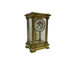 Late 19th century French brass four glass mantle clock by Samuel Marti of Paris, c1880 case on a recessed stepped plinth with four twisted columns and Corinthian capitals to the four corners, with a two- part enamel dial, Roman numerals and minute markers, non matching steel hands and visible Brocot escapement with cornelian pallets, 8-day rack striking movement stamped “Medaille de bronze” with chamfered pendulum bob and key.