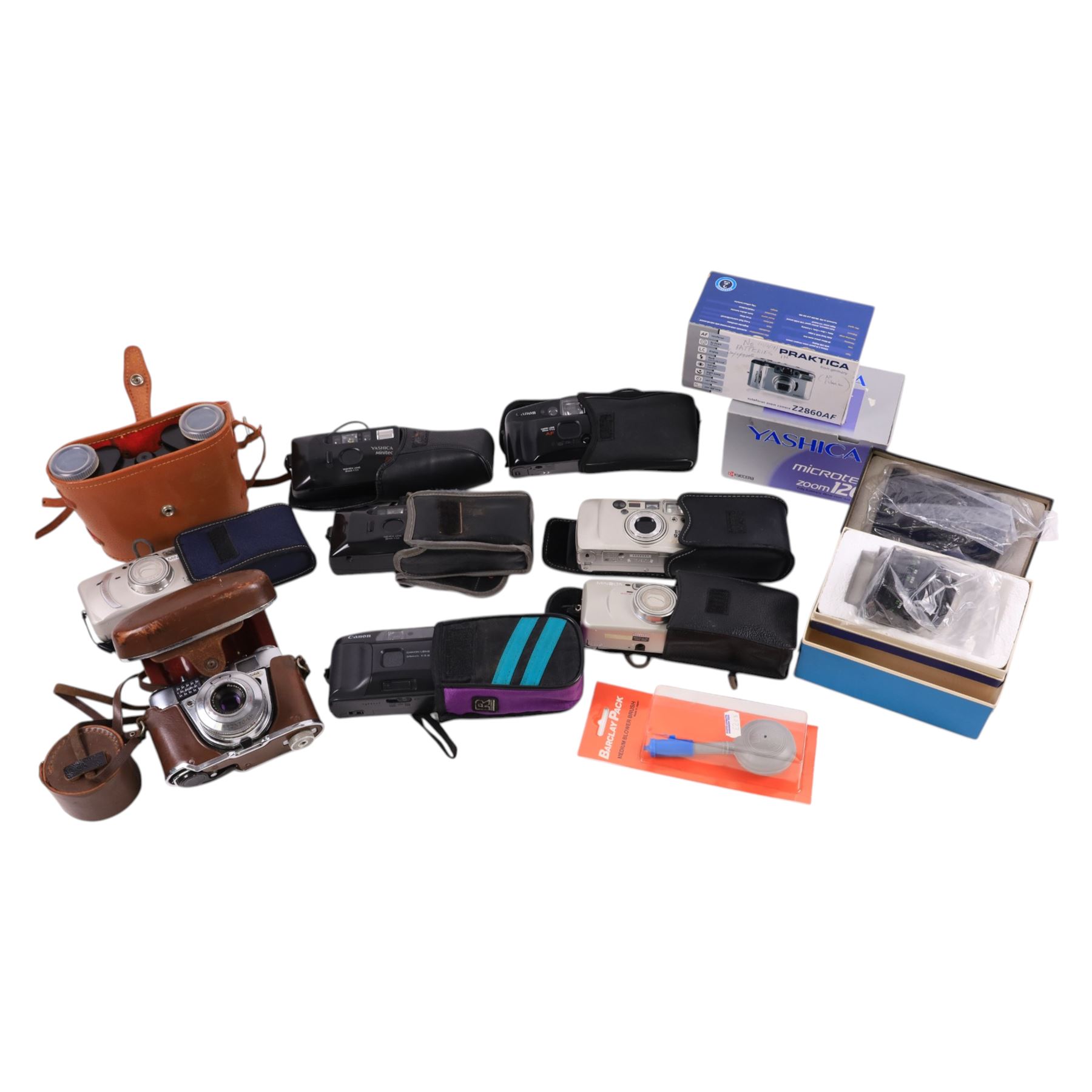 Collection of compact cameras, including Yashica, Minolta and Praktica examples, Boots binoculars, two Pentacon lenses and other accessories