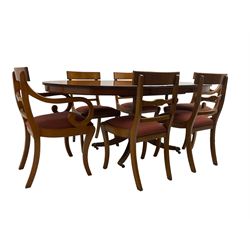 Regency design yew wood dining table, oval cross-banded top with reeded edge, raised on turned pedestal with reeded sabre supports terminating in brass hairy paw feet and castors (W138cm D100cm H75cm); and Rackstraw - set six (4+2) Regency design dining chairs with red drop-in seats (W50cm H86cm)