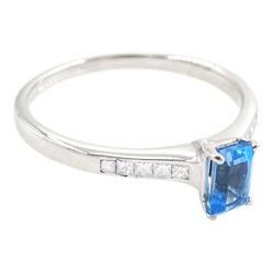 18ct white gold blue topaz and diamond ring, the single emerald cut topaz of approx 0.65 carat, each shoulder set with five, channel set princess cut diamonds