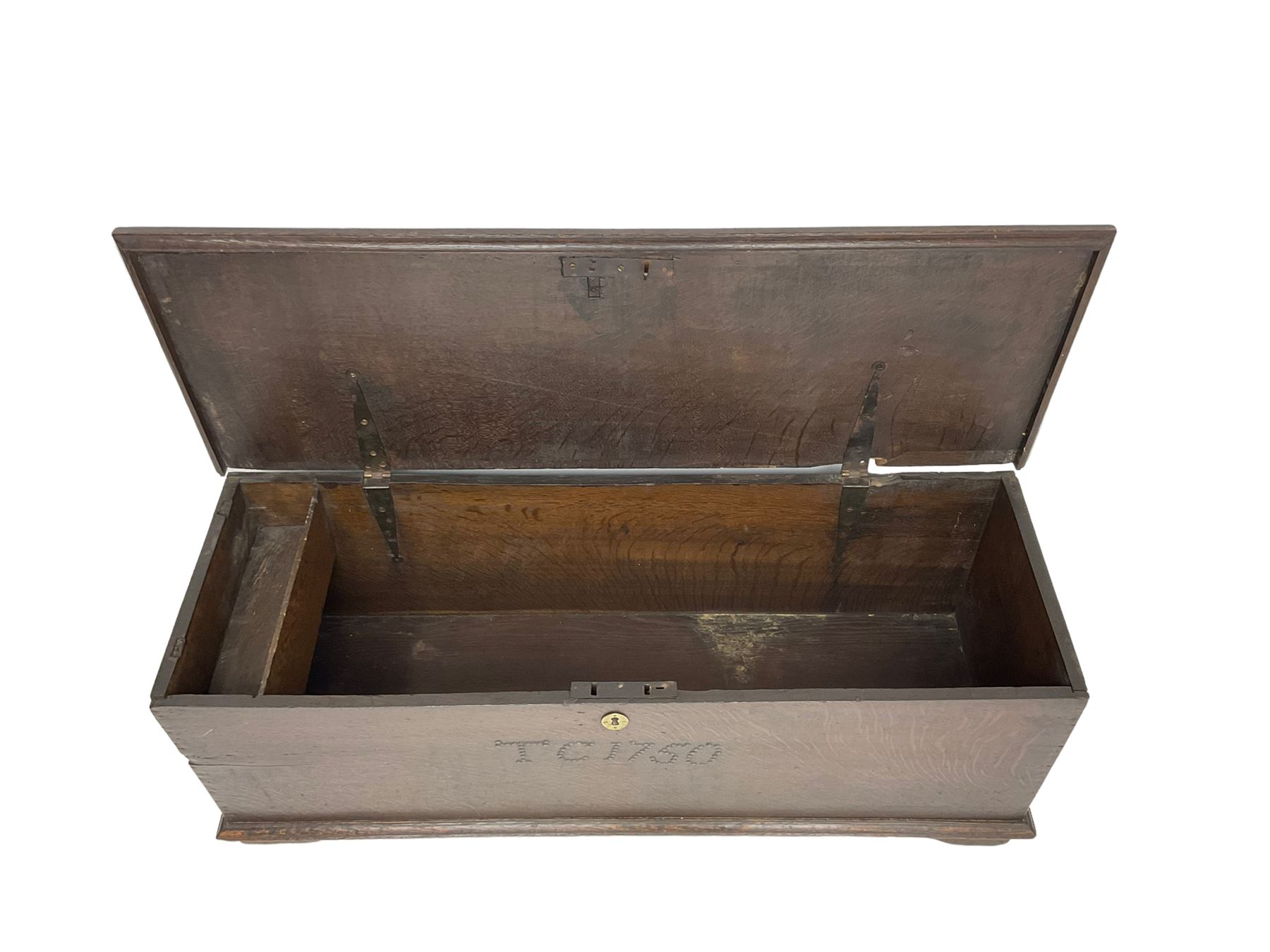 18th century oak sword chest or coffer, hinged lid with moulded edge and iron fittings concealing candle box and main compartment, the front with studwork spelling 'TC 1750', raised on bracket feet