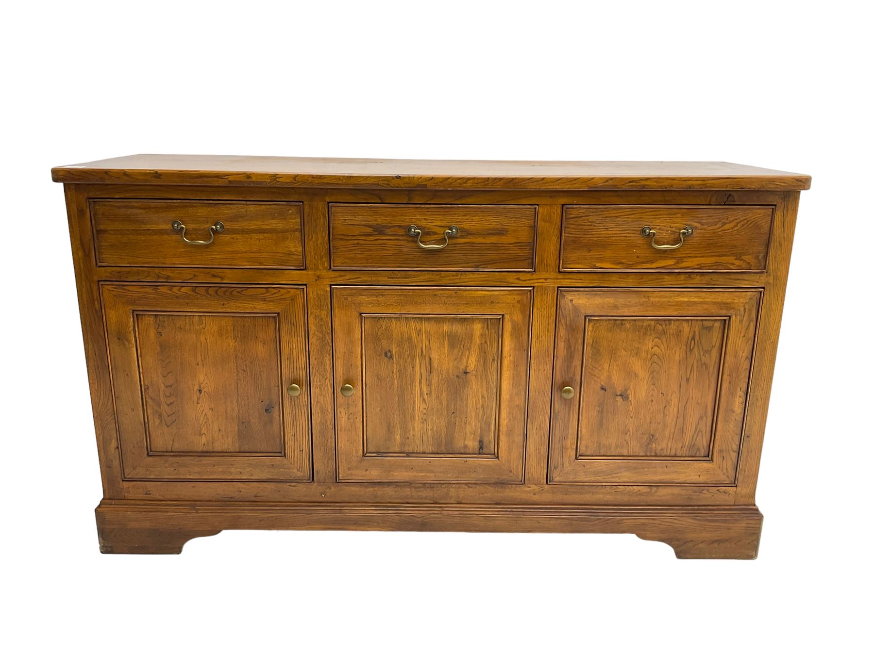 Willis & Gambier - oak sideboard, three drawers over three panelled cupboards, on bracket feet 