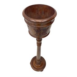 Inlaid hardwood plant stand, with carved decoration and scrolling metal inlays, turned stem on moulded circular platform base