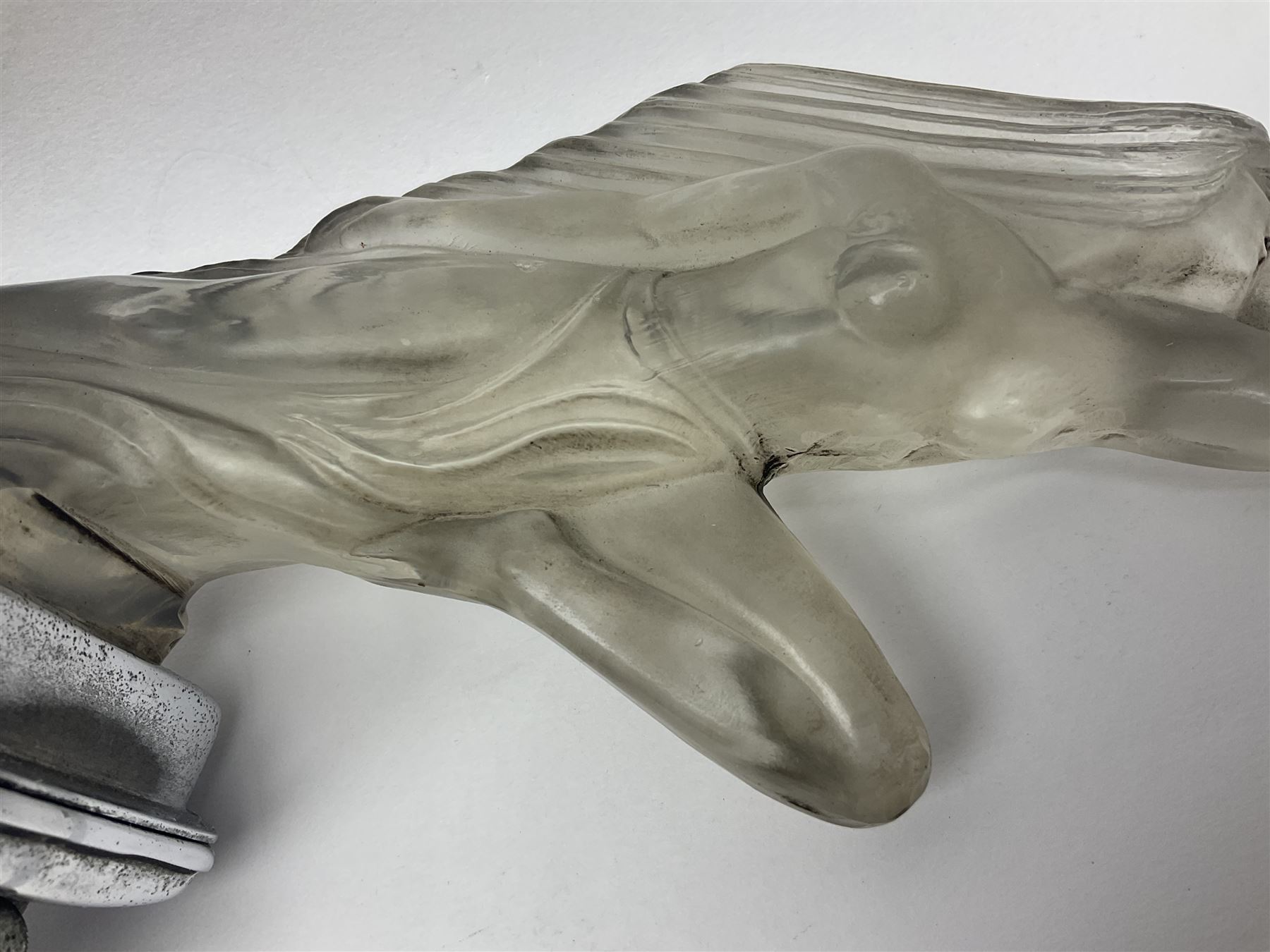 Red Ashay glass car mascot, circa 1929, Acceleration, modelled in frosted Art Deco glass as a nude woman leaping forward, attached to car mounting bracket, L24cm, H18cm 