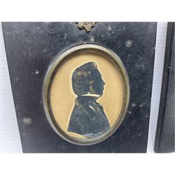 Two early 19th century silhouettes, the first example depicting the side profile of s gentleman, with gilt detailing, stamped J.I Manginn verso, the second example depicting the side profile of a female in a bonnet, indistinctly signed verso, both within laquered wooden frames, frame H13cm