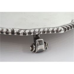 Modern silver waiter, of circular form, with oblique gadrooned rim, upon three scroll pad feet, hallmarked Roberts & Belk Ltd, Sheffield 1987, D14.7cm, approximate weight 5.4 ozt (168.2 grams)