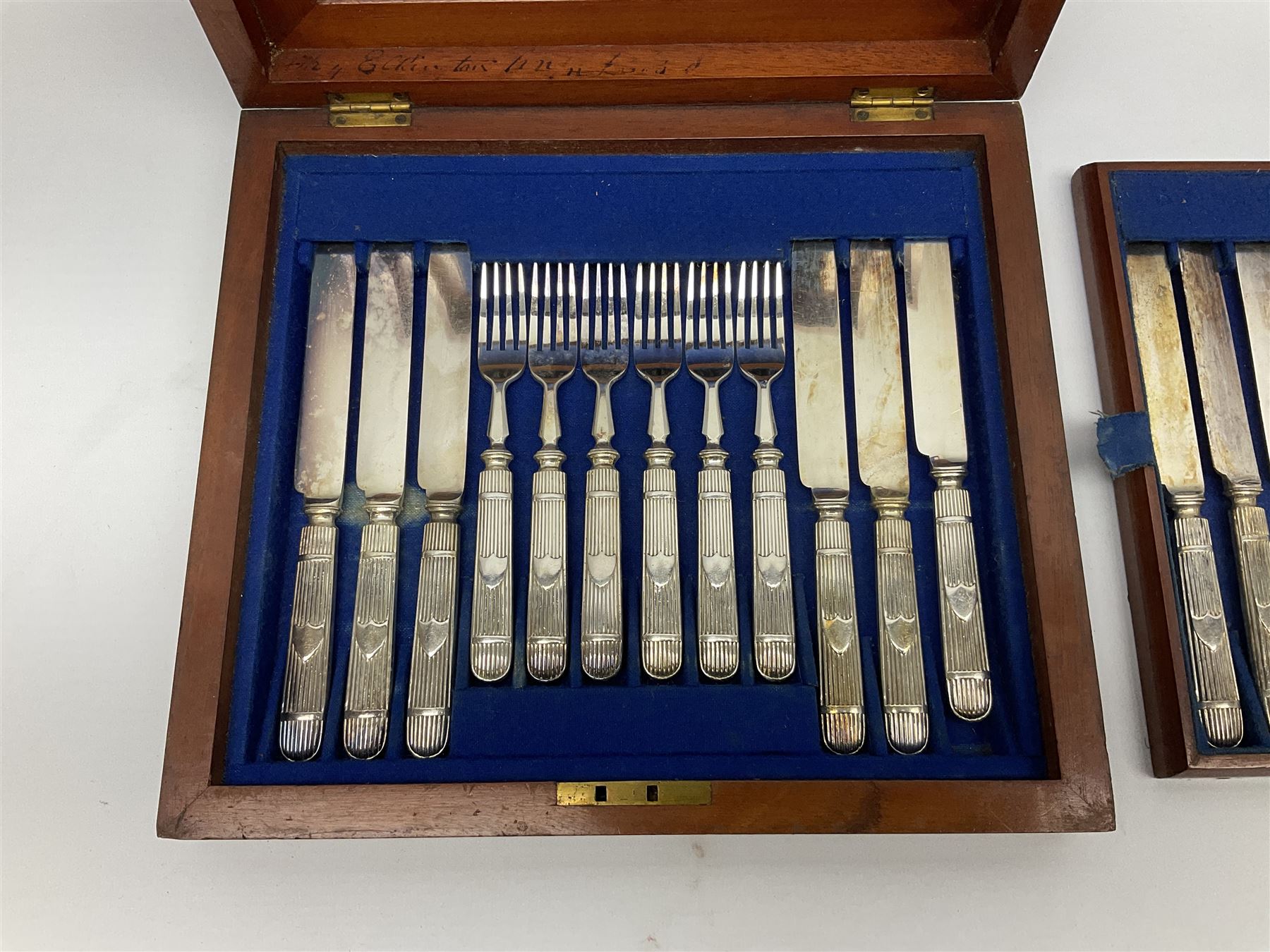Victorian silver plated dessert set by Elkington & Co for twelve place settings, each reeded handle with vacant cartouche, each with Elkington & Co mark, date letter for 1861, and registration lozenge, contained within a mahogany case with vacant brass cartouche to the hinged cover, opening to reveal a Royal blue baize lined interior with removable tray, case H6cm W29.5cm D26.5cm