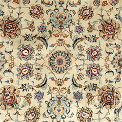 Central Persian Kashan hand-knotted carpet, cream ground with radiating floral rosette medallion in soft blue and terracotta, the field filled with stylised blooms, cloudband vines and palmette motifs, enclosed by triple borders featuring lotus and boteh designs, with cotton fringe ends 