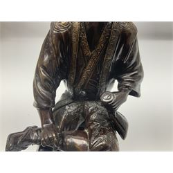 Oriental bronze figure of a gentleman, modelled seated upon barrel with a pipe in one hand and a flask in the other, H21cm