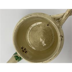18th century creamware teapot, probably Leeds, with reeded entwined handle and floral finial to the cover, the body with hand painted polychrome decoration of figure to one side, and floral spray to the other, collectors paper label beneath inscribed Leeds Pottery, H11.5cm