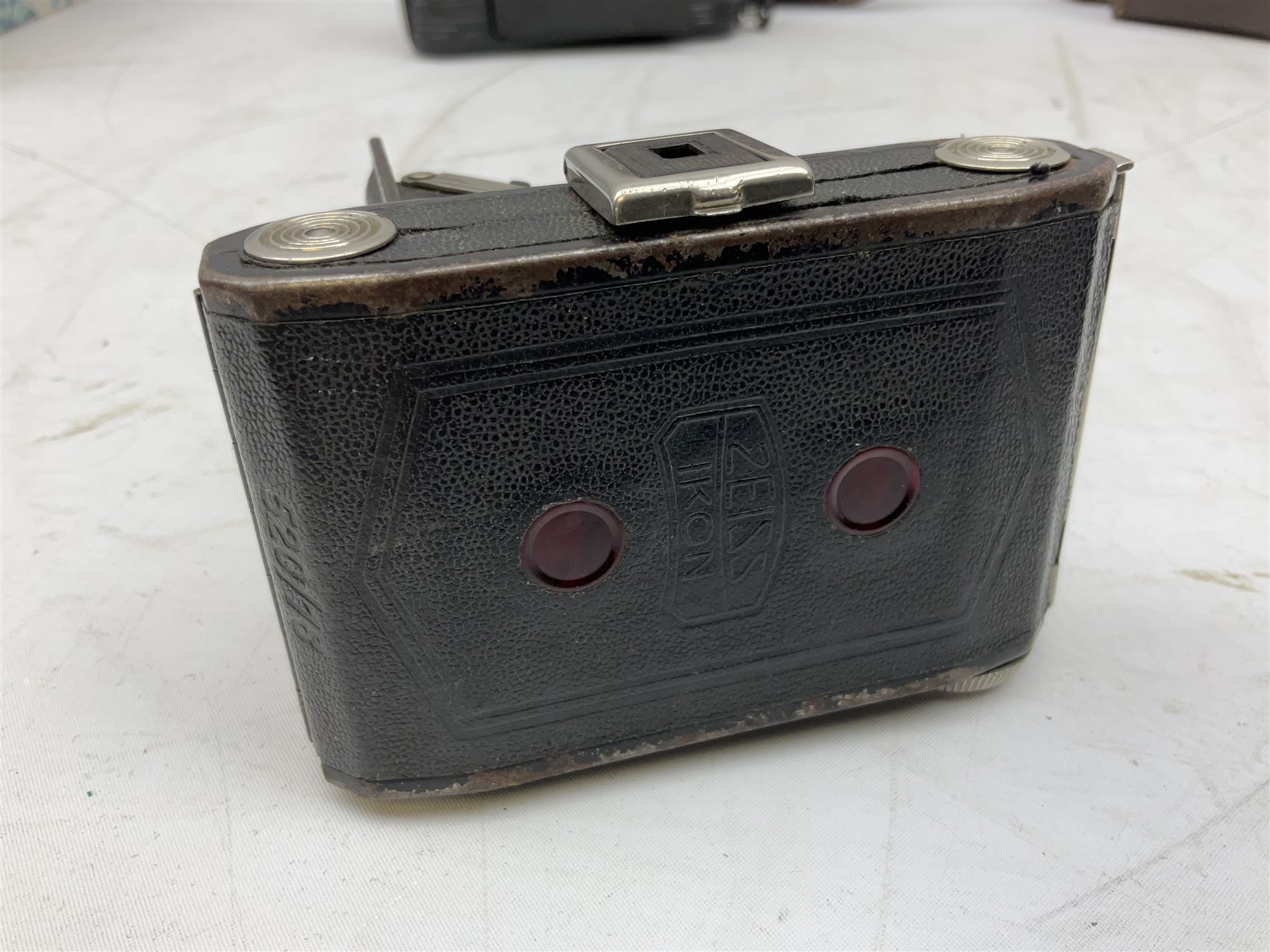 Bilora Boy Box Camera, with leather case, together with Zeiss Ikonta folding camera and another similar example 