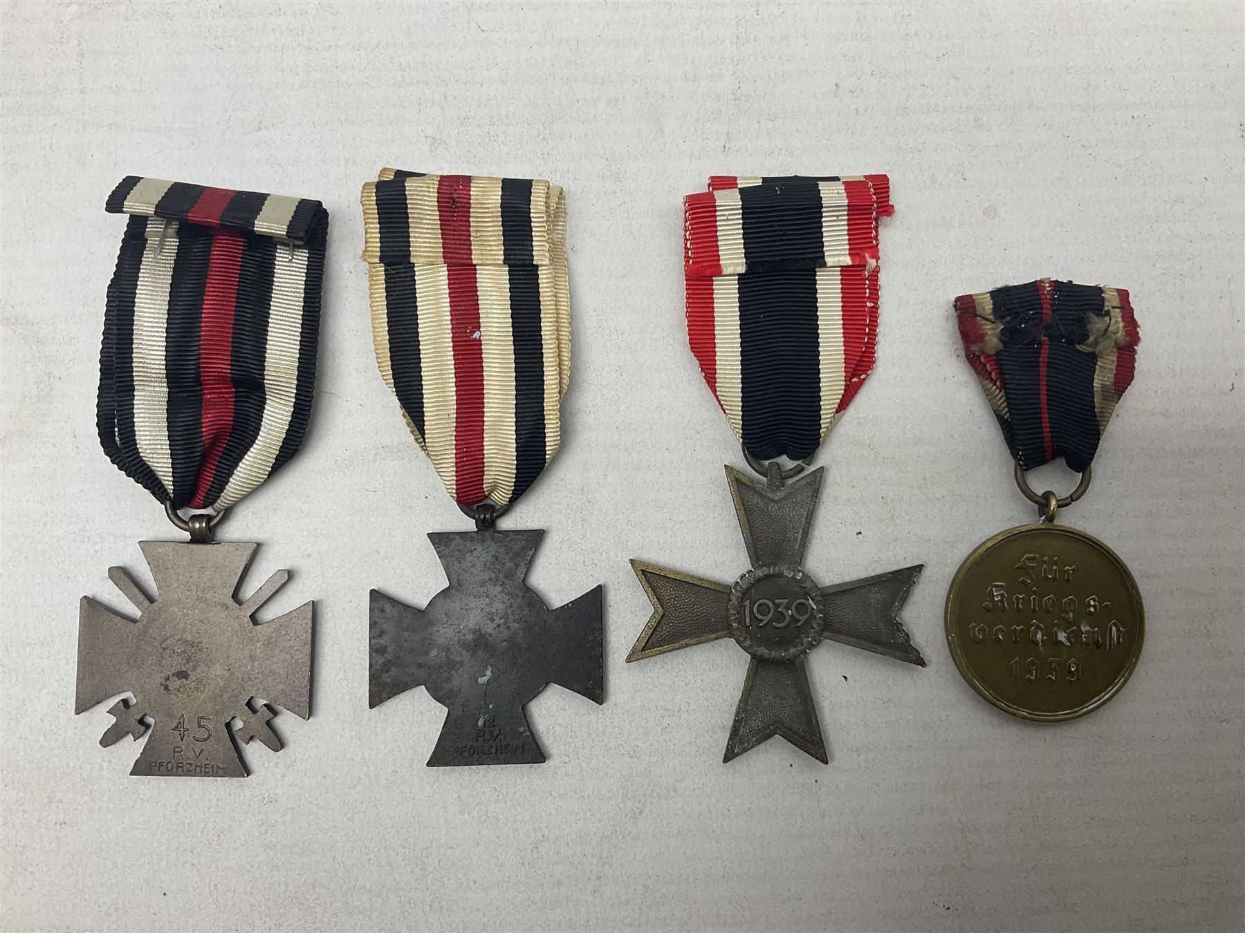 Two WW1 German medals - copy Cross of Honour with swords (combatants); Cross of Honour without swords (non-combatants); and two WW2 German medals - War Merit Medal; and War Merit Cross; all with ribbons (4)