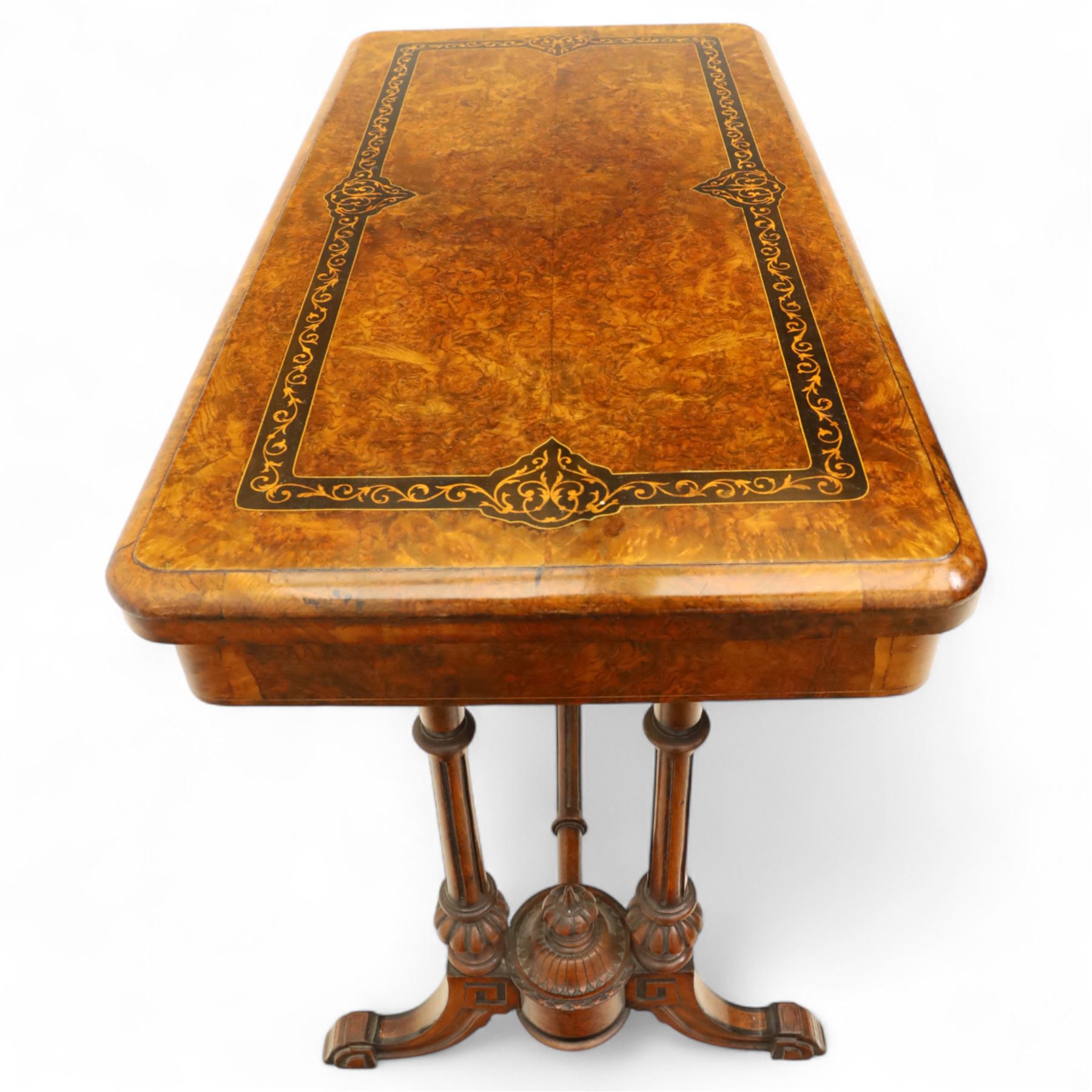 Victorian walnut and inlaid games table, rectangular fold-over top with figured walnut veneers and foliate inlay, swivel and fold over to reveal a green baize lined playing surface, on twin supports united by a stretcher, raised on scroll carved feet with castors (extended 96cm x 92cm)