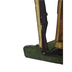 Military Outfitters hand painted life size wooden cut out figure of a WW1 soldier standing at ease holding a gun by his side, marked Stening Signs; hardboard on planked frame H199cm