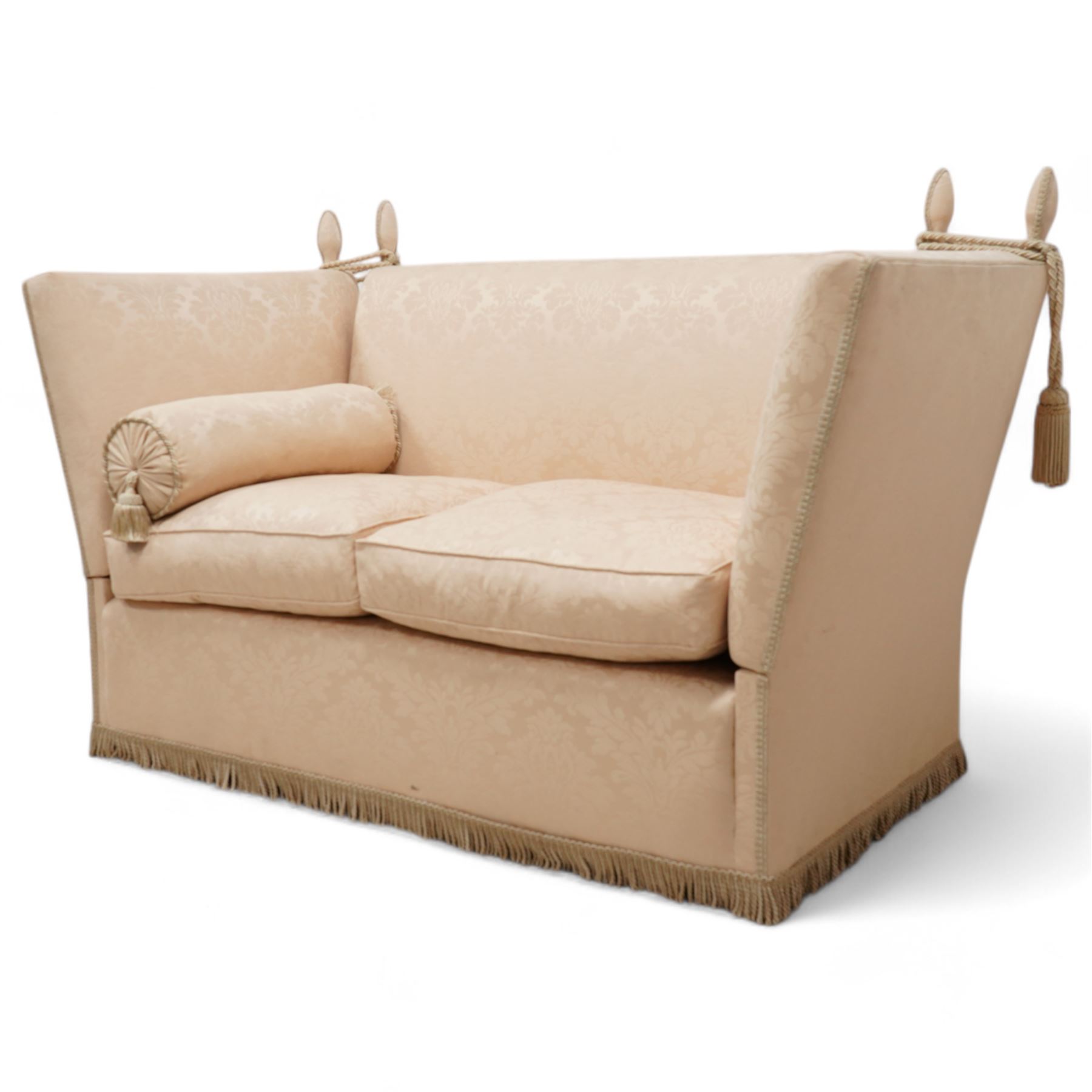 Knole design hardwood-framed drop-arm two-seat sofa, upholstered in cream Damask fabric decorated with repeating foliate pattern, with twist fringe, 