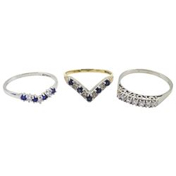 White gold seven stone cubic zirconia ring, with 'love' gallery, white gold cubic zirconia wishbone ring, both 14ct and a 9ct gold sapphire and diamond chip wishbone ring, all hallmarked 