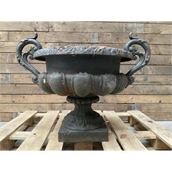 Victorian design ornate cast iron centrepiece urn, featuring two handles, raised on footed base