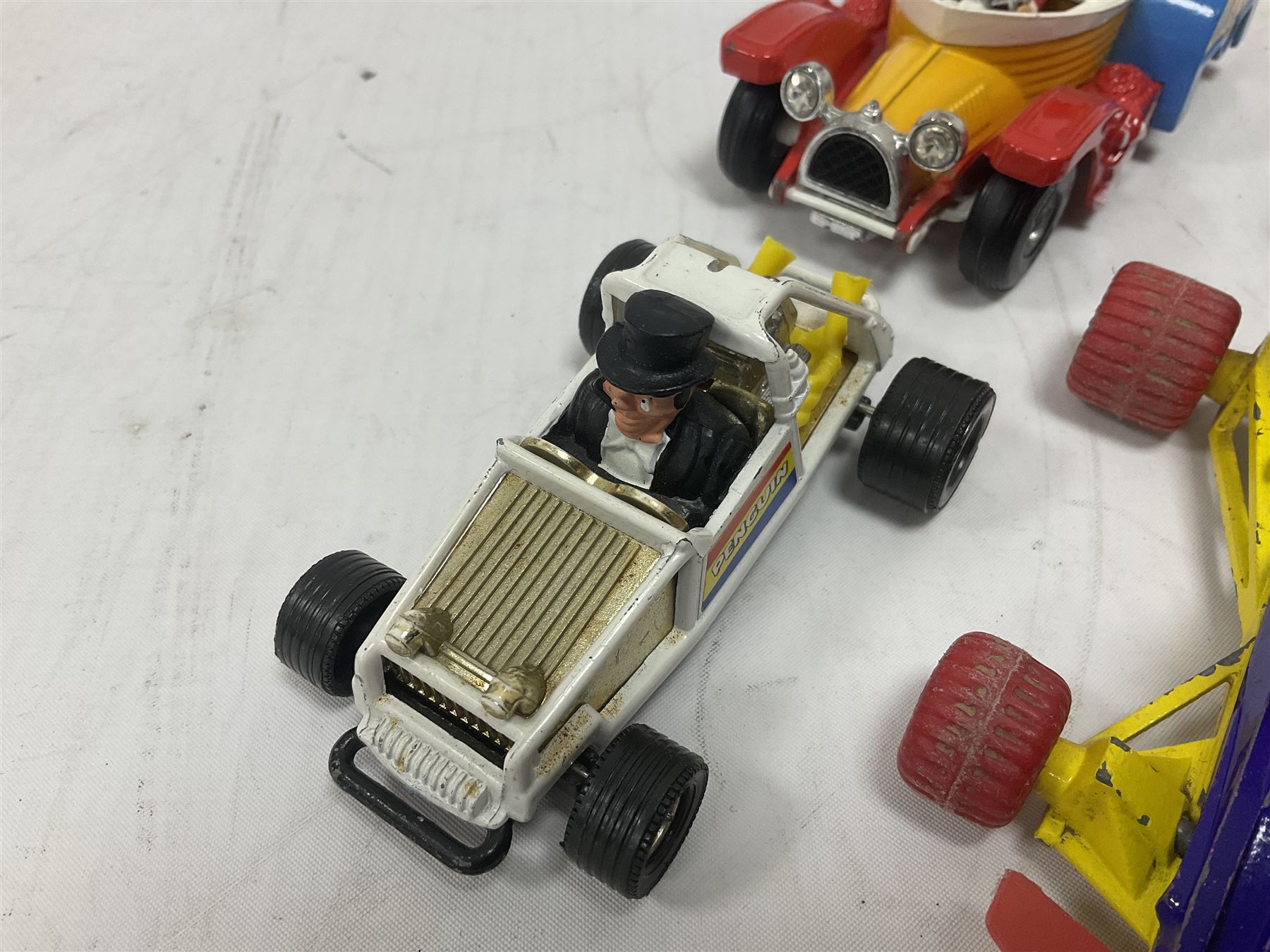 Corgi - ten unboxed and playworn TV/Film related die-cast models including three Popeye Paddle Wagons; Dick Dastardly; Magic Roundabout; Muppets; Batman Penguinmobile; and Basil Brush (10)