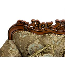 Italian Baroque design three seat sofa, hardwood framed, the cresting rail carved and pierced with c-scrolls and flower heads, scrolled arms, upholstered in floral patterned and striped fabric, with scatter cushions 