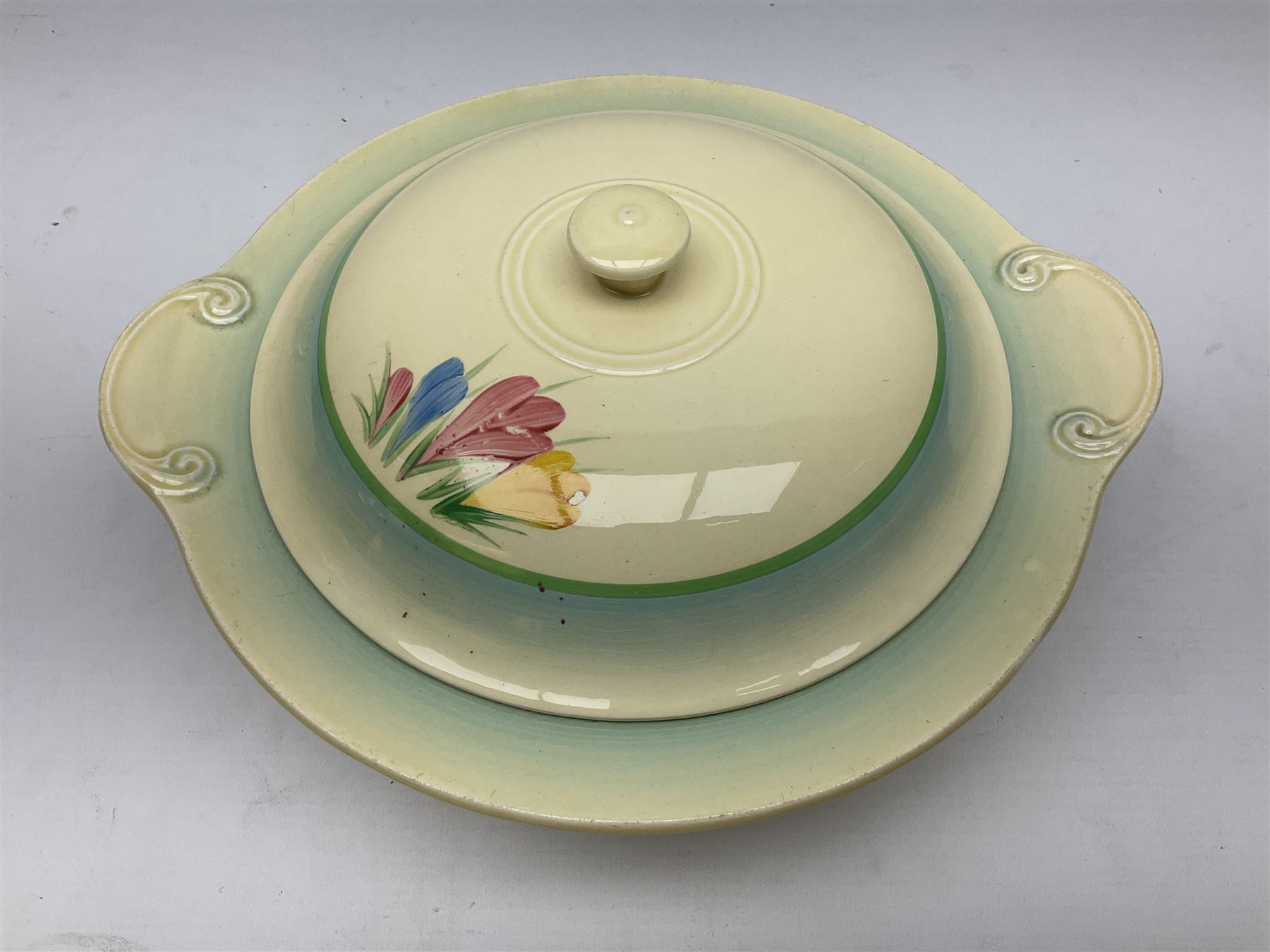 Clarice Cliff twin handled lidded tureen decorated in the Crocus pattern, with printed and impressed marks beneath, W27cm