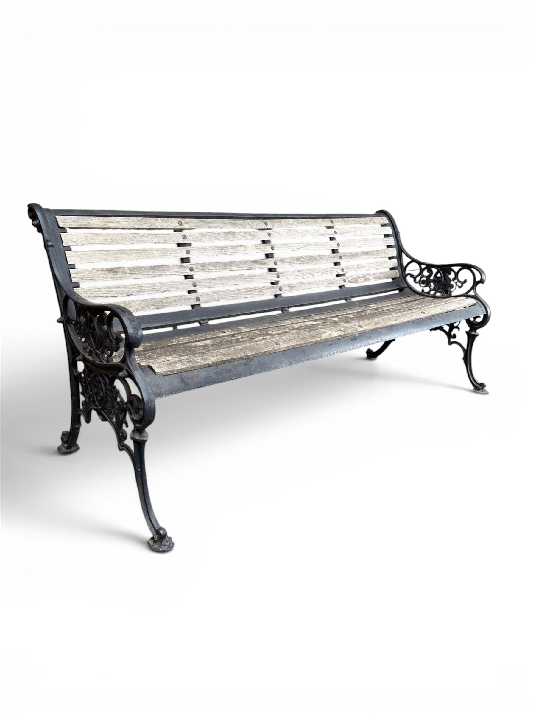 Victorian Andrew McLaren pattern cast iron bench, the ornate ends with detailed scrollwork, joined together with a cast iron seat and backrest frame supporting gently weathered oak slats, Victorian diamond stamp mark