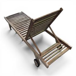 Pair of teak garden sun loungers, with slatted adjustable backrests, integrated wheels and sliding pull-out side trays, weathered natural finish.