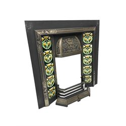 Victorian design cast iron fire inset, the hood with floral decoration, fitted with floral upright tiles