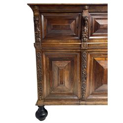 Late 17th century Flemish/Dutch rosewood and oak ‘Zeeuwse Kast’ or cupboard, projecting cornice carved with three putti masks, the uprights carved with lion masks over ribbons, flower heads and foliage, enclosed by four geometric panelled doors, lower central upright carved with flower head over foliate ribbon with bird among foliage, the escutcheon hidden by swivel berry carved cover, interior fitted with shelves, two drawers and shallow hinged cupboard, on two large turned and ebonised feet, circa 1680