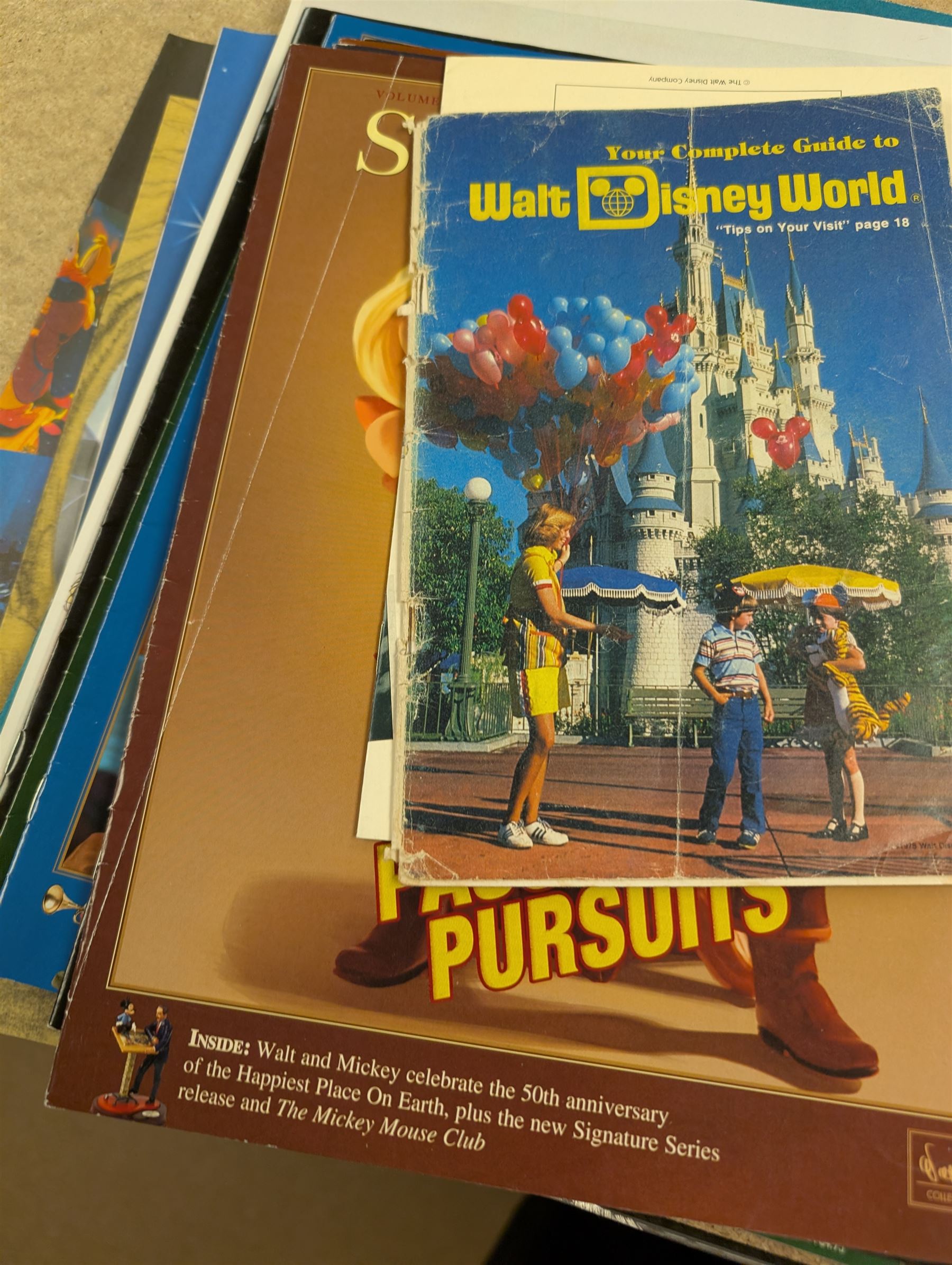 Collection of Disney memorabilia and ephemera, including Walt Disney Treasures DVD, two Disney Villains mugs, enamel pins, Mickey Mouse D23 fan club pack, Disney Twenty-Three magazines, Sketches magazines, etc