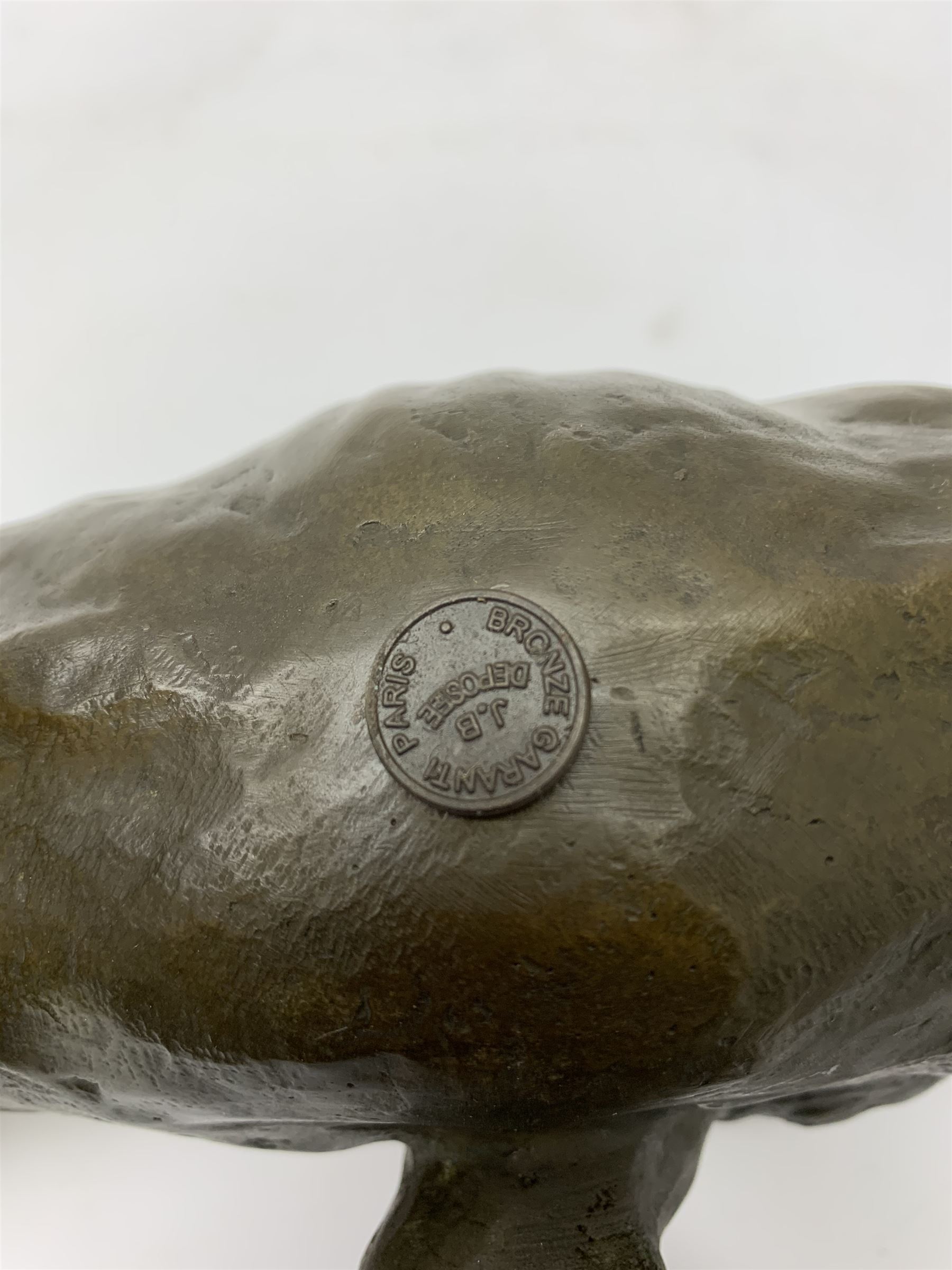 A bronze figure, modelled as a cougar in crouching pose, signed Milo and with foundry mark, L40cm.
