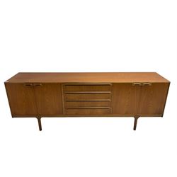 Tom Robertson for AH McIntosh & Co of Kirkaldy - mid-20th century teak sideboard, fitted with four central drawers, flanked by cupboard enclosing shelves and sliding tray, raised on cylindrical supports