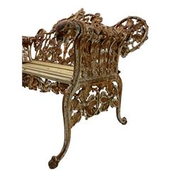 Coalbrookedale design - pair of late 19th to early 20th century 'oak and ivy' pattern cast iron garden benches, the open back decorated with trailing oak and ivy leaves, oak slatted seat, the rolled arms with hound mask terminals, on splayed and scrolled supports