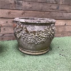 Pair of cast stone planters decorated in grapes