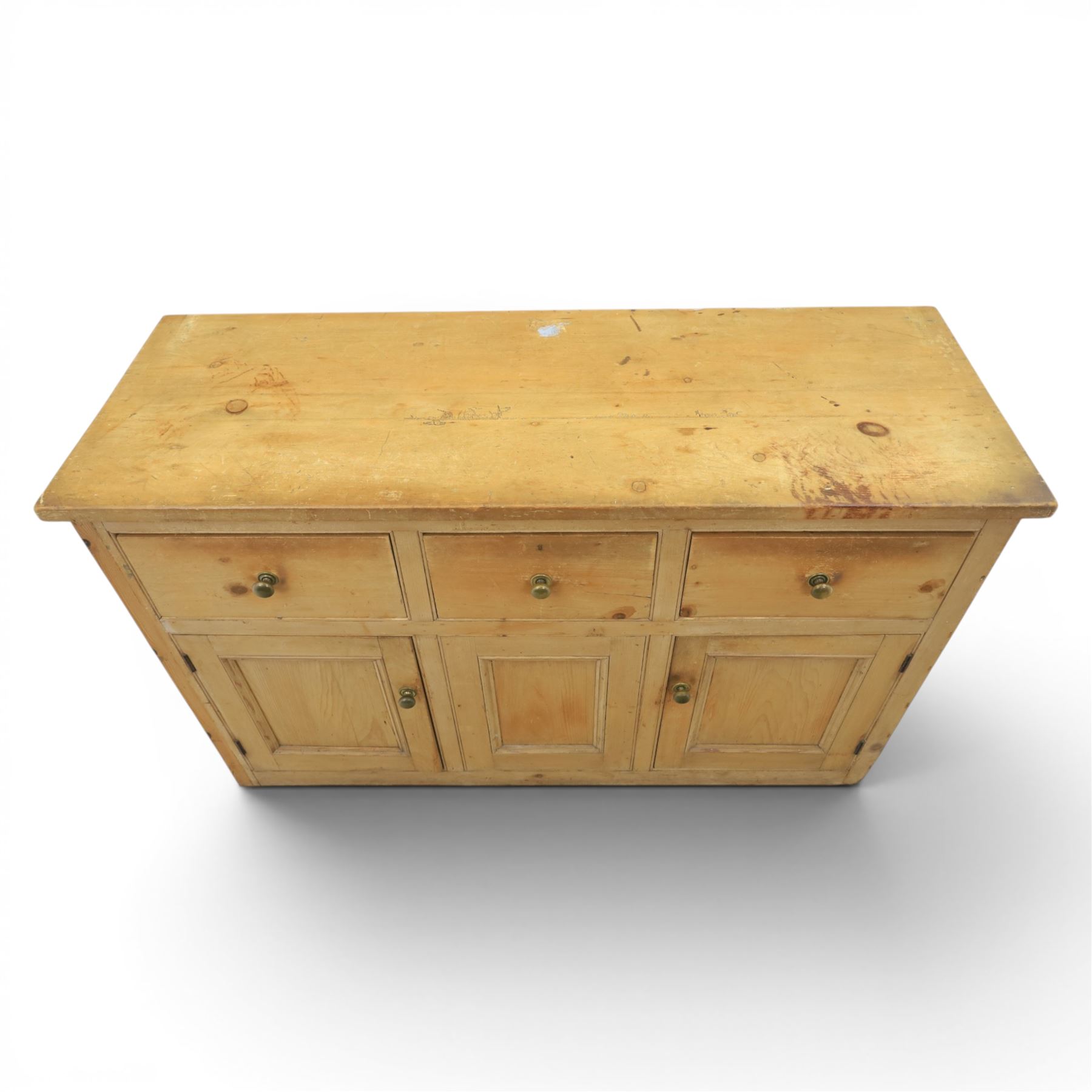 Victorian pine dresser base, with rectangular plank top, above three short drawers over two cupboard doors
