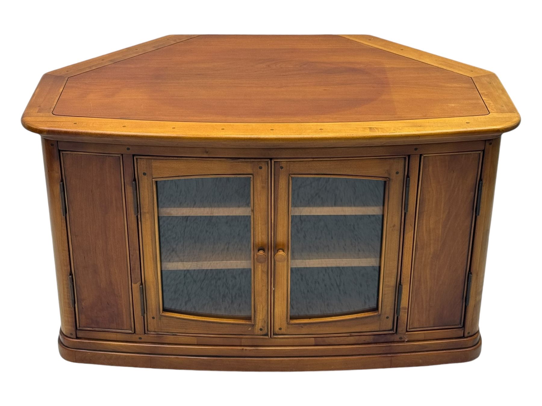 Contemporary cherry wood corner TV unit, canted top over central glazed double doors opening to shelves for media storage, flanked by side storage compartments, on a plinth base