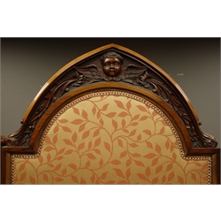  Late Victorian walnut framed four panel upholstered dressing screen, Gothic pointed arch cresting carved with winged cherub heads and foliage, H186cm, W224cm  