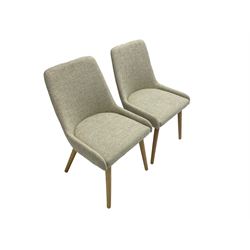 Pair contemporary side chairs, upholstered in light grey fabric, on splayed supports