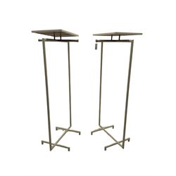 Pair of contemporary shops display clothes rails, rectangular display shelf over burnished metal clothes rails on white finish frame stands