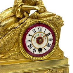 A Napoleon III c1860 French Ormolu mantle clock with a reclining figure of an oriental lady on a stepped plinth, base with splayed feet and raised decoration comprising scroll work and acanthus leaves, with a white and rouge enamel dial with hand painted floral decoration, roman numerals, minute track and brass spade hands, eight-day timepiece movement with pendulum.

