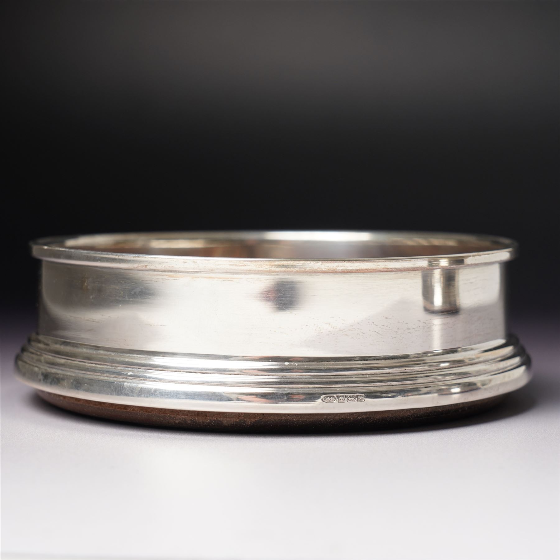 Pair of Elizabeth II silver bottle coasters with turned wooden bases D12cm, Birmingham 1994 Maker W I Broadway & Co.